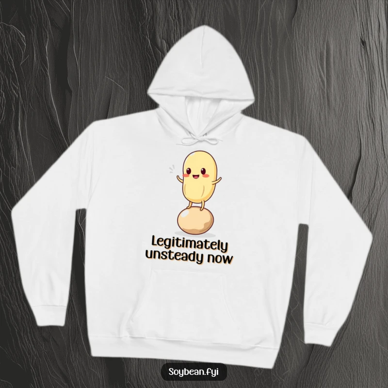 Funny hoodie with a delightful kawaii soybean character attempting to balance on one bean, showcasing a funny and endearing wobble.