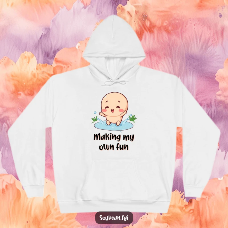 Funny hoodie depicting a happy soybean character splashing gleefully in a tiny puddle, perfect for spreading joy and cozying up.